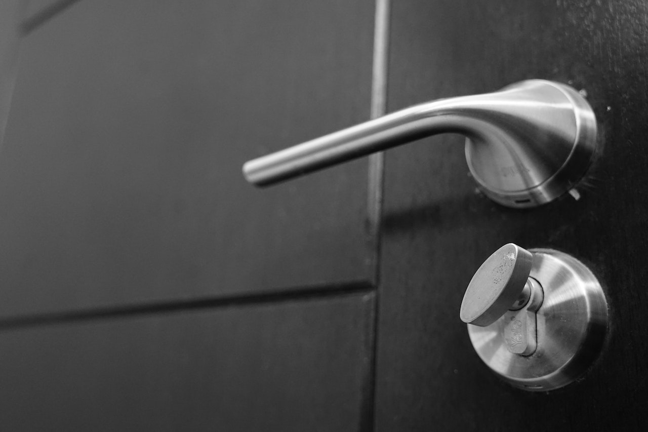 close up photography of gray stainless steel door lever and lock