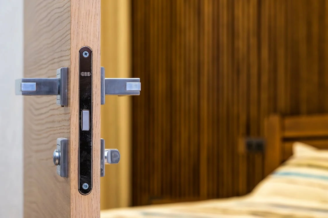 open entry door with bed in background